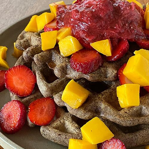 vegan and gluten free buckwheat waffles with strawberries, mango, strawberry rhubarb jam and medicinal mushroom infused maple syrup.