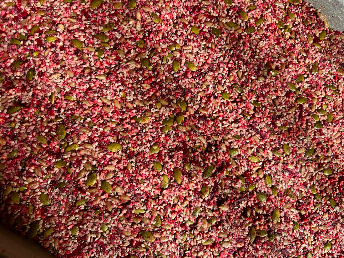 the whole image is has specks of blended pumpkin seeds, pink beets and various other nuts. It is a thick sheet of blended nuts turned pink by the beets